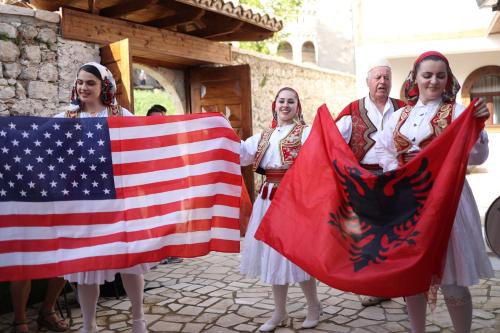 a group of people holding an american and flag at Kruja Albergo Diffuso , Inside Kruja Castle in Krujë