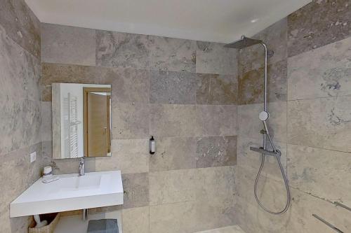 a bathroom with a sink and a shower at ARGIALE - ARGHJALE in Figari