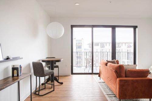 a living room with a couch and a table at Chic East Side 1BR Apt with Balcony, Pool, and Gym in Milwaukee