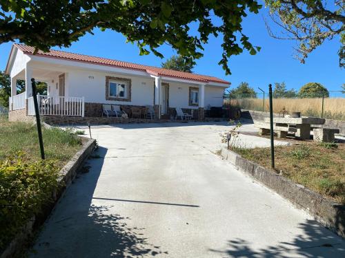 a small white house with a driveway at “Casa abella “ in La Magdalena