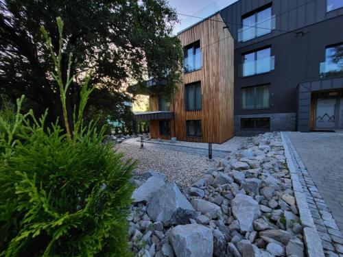 a stone path in front of a building at Apartamenty Nowa Osada - by VillaOlimpijska2 in Wisła