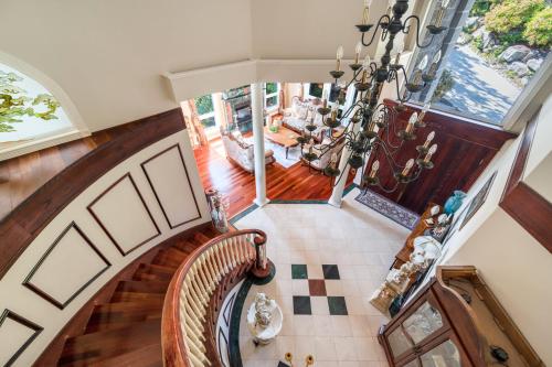 an overhead view of a staircase with a chandelier at The West Vancouver luxurious house in West Vancouver
