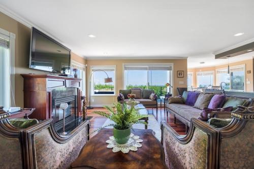a living room with a couch and a table at The West Vancouver luxurious house in West Vancouver