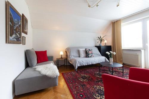 a living room with a couch and a chair at Apartments Kosir in Kranjska Gora