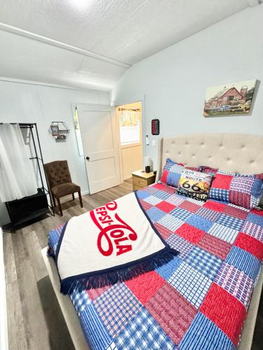 a bedroom with a bed with a blanket on it at Route 66 Pop Stop-Minutes to Main St in Bandera