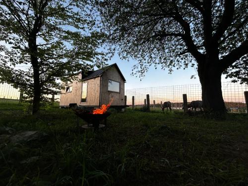 a house sitting on top of a fire in a field at FAJNhaus in Jakartovice