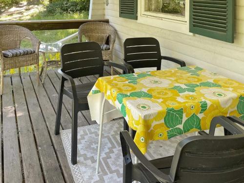 a table and chairs sitting on a porch with a table at 4 star holiday home in Backaryd in Backaryd