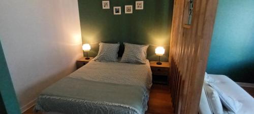 a small bedroom with two beds and two lamps at le studio de Dalie in Honfleur