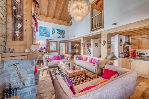 un salon avec des canapés et une cheminée dans l'établissement Chalet Zanskar - Chalet 5 - 180m2 - 6 chambres, 6 salles de bain, jacuzzi MAE-3407, à Les Boisses
