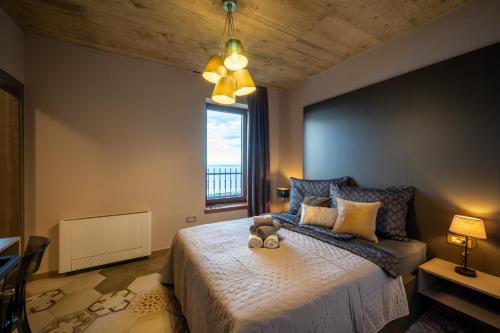 a bedroom with a bed with a teddy bear on it at Vila Marigold in Opatija