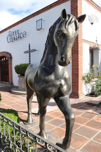 a statue of a horse in front of a building at Hotel Cuamanco in Huamantla