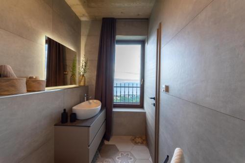 a bathroom with a sink and a window at Vila Marigold in Opatija