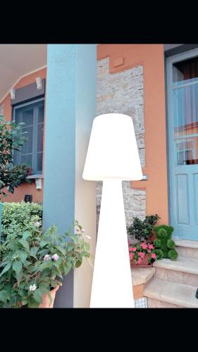 a white lamp sitting in front of a house at Art action room in Villanovafranca