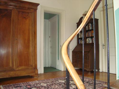 a wooden staircase in a room with a book shelf at Chalet Du Bel Event in La Chapelle-sur-Dun