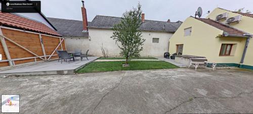 a backyard of a house with a patio at Rust's Country Lodge in Unterfrauenhaid