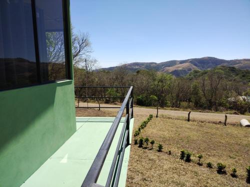 a balcony of a house with a view of a field at Cielo Azul in Monteverde Costa Rica