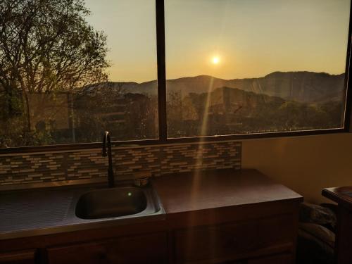 a kitchen sink and a window with a view at Cielo Azul in Monteverde Costa Rica