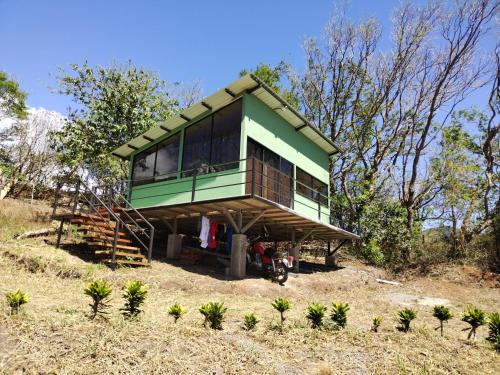a green house on top of a hill at Cielo Azul in Monteverde Costa Rica