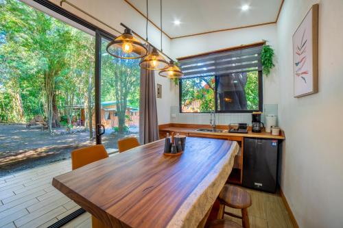 a kitchen with a wooden table and a large window at Bromelia Studio in Monteverde Costa Rica