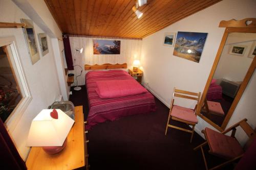 a small bedroom with a bed and a table and a desk at Résidence Les Avenieres - LES AVENIERES - AV30E MAE-4224 in Villarodin-Bourget