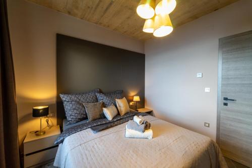 a bedroom with a bed with a teddy bear on it at Vila Marigold in Opatija