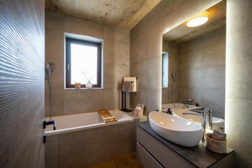 a bathroom with a sink and a bath tub and a sink at Vila Marigold in Opatija