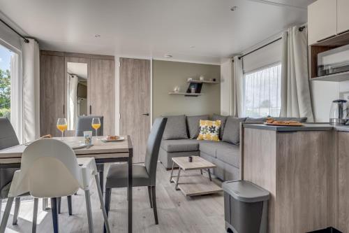 a kitchen and living room with a couch and a table at Bondi Beach in Renesse