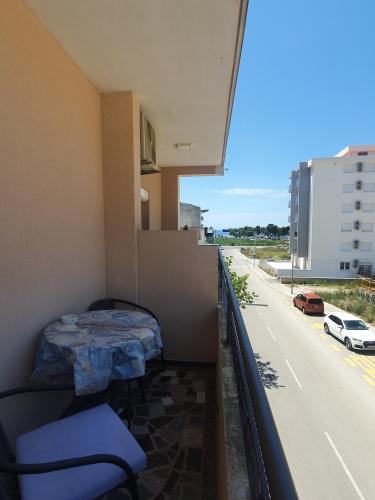 a room with a balcony with a bed and a street at Apartments Luna in Bar
