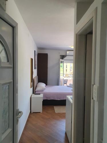 a small bedroom with a bed and a doorway at Apartments Luna in Bar