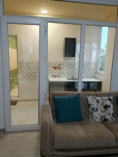 a living room with a couch and a kitchen at New Wave1 in Grigoleti