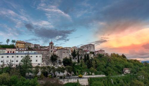 a city on top of a hill with a sunset at Meridiana in Santa Maria del Molise