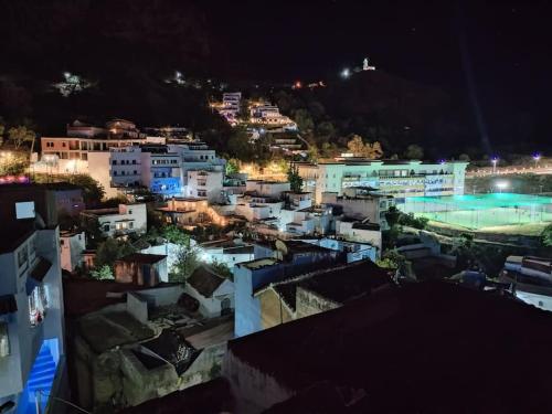 a view of a city at night at El Sama' family house Rooftop 80m2 in Chefchaouene
