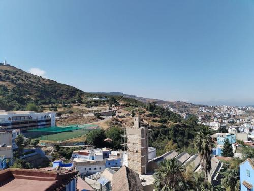 an aerial view of a city with a mountain at El Sama' family house Rooftop 80m2 in Chefchaouene
