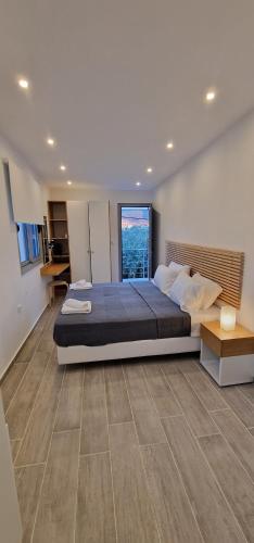 a bedroom with a large bed and a large window at VILLA KASABLANCA in Skala Rachoniou