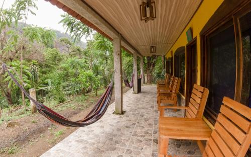 a porch with a hammock on a house at El Retiro Lanquin in Lanquín