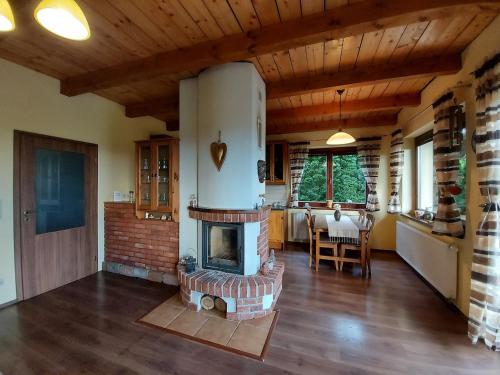 a living room with a brick fireplace in a house at Chalet Červená Veža in Banka