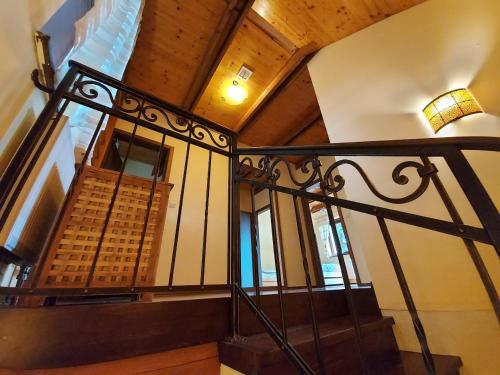 a staircase with a wrought iron railing in a building at Chalet Červená Veža in Banka