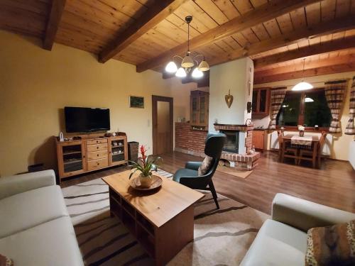 a living room with a couch and a table at Chalet Červená Veža in Banka