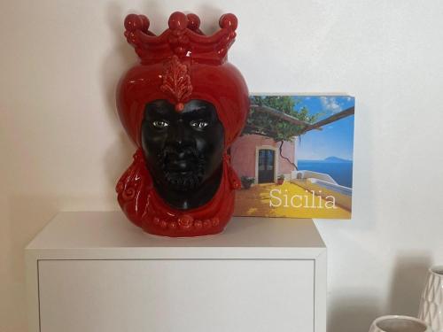 a black mask with a crown on top of a dresser at Teresita in Monreale