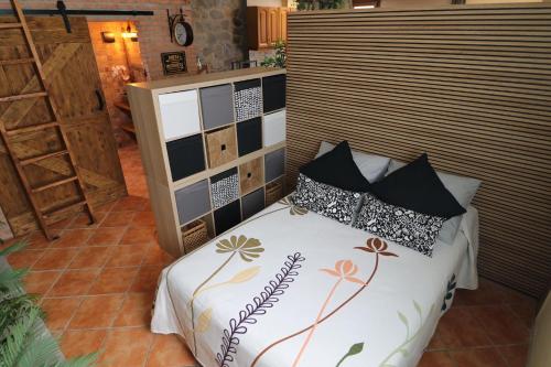 a bedroom with a bed with pillows on it at La Porteria in Viladomíu Vella