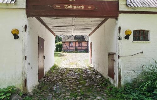 an empty alleyway with a building in the background at Cozy Home In Præstø With Kitchen in Præstø