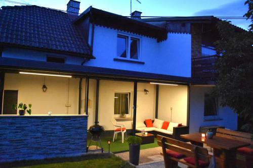 uma casa azul e branca com um pátio em Apartma Franko em Cerklje na Gorenjskem