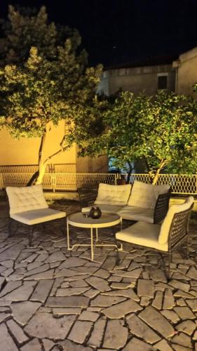 a group of chairs and tables on a patio at Serenita Stone House in Becici
