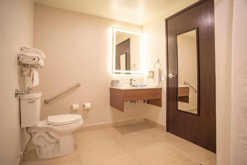 a bathroom with a toilet and a sink at Holiday Inn Express Guadalajara Iteso by IHG in Guadalajara
