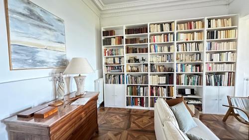 un salon avec une étagère remplie de livres dans l'établissement VILLA VALENTINE, vue panoramique sur la mer et les iles, Corniche Kennedy, Marseille, à Marseille
