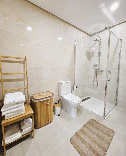 a bathroom with a toilet and a glass shower at Casa do Moinho in Cabeceiras de Basto