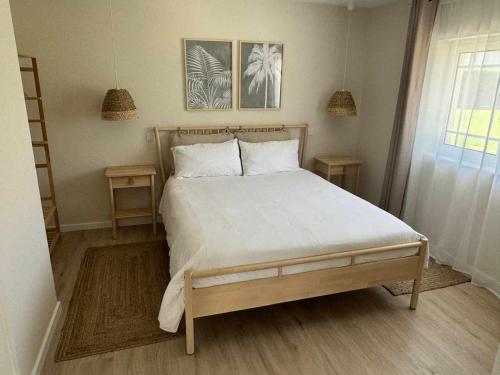 a bedroom with a large bed with two night stands at 180 Guest Suite in Ovar