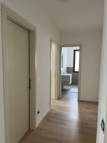 an empty hallway with two doors and a bathroom at Bollicine&Relax in Col San Martino