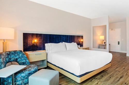 a hotel room with a bed and a chair at EVEN Hotel Waco - University Area by IHG in Waco