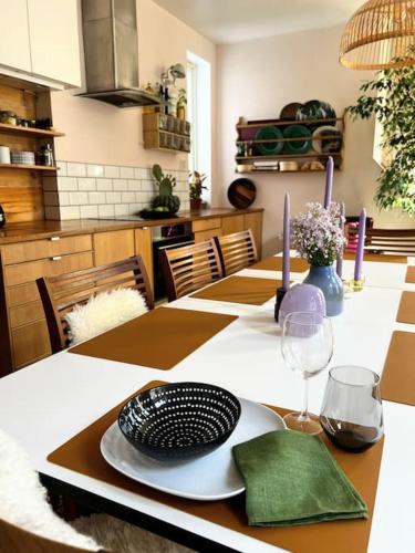 a dining room table with a plate on top of it at Spacious historical art oasis in the city center in Bergen